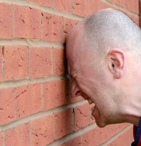 Our Consultant Headbutting a Wall after reading yet another dreadful accountancy CV